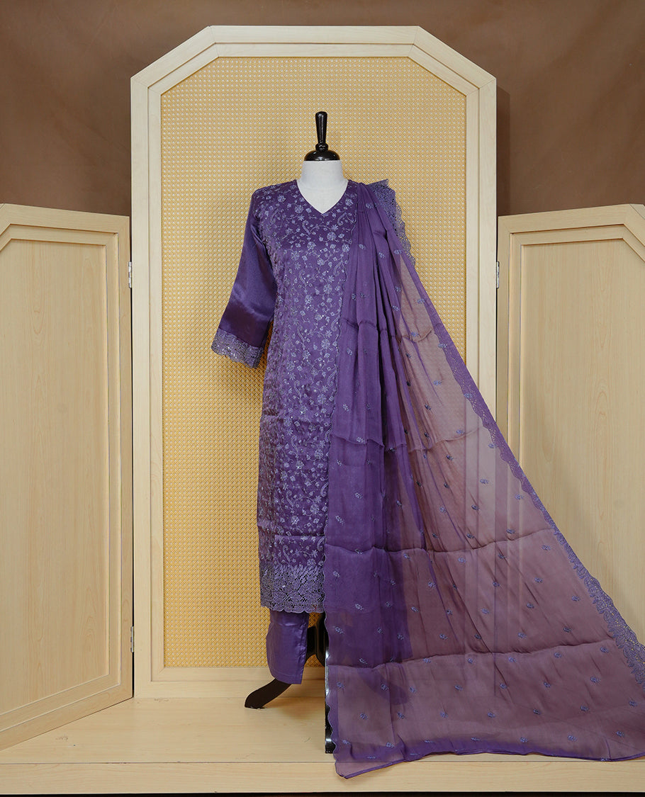Greyish Purple colour churidar set with floral thread embroidery on body & V-neckline, paired with a matching embroidered dupatta and solid pants.