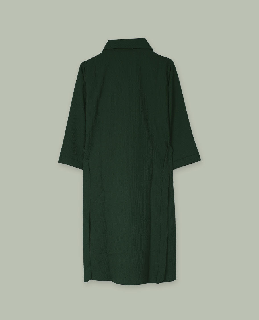 Deep forest green open-front shrug with collared neckline and three-quarter sleeves, layered over a white floral graphic tank top