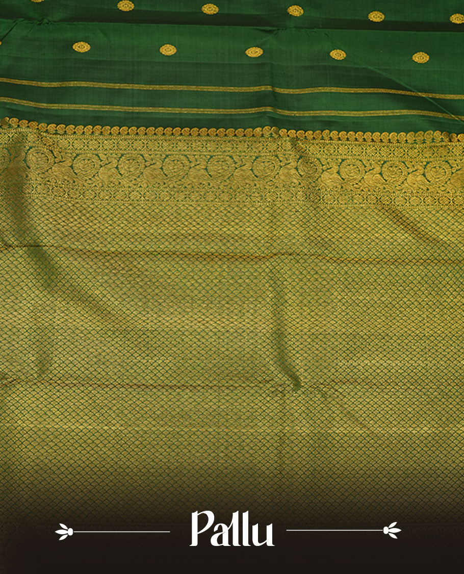 Bottle green pure traditional Kancheepuram silk saree adorned with gold zari chakra motifs across the body, featuring elegant gold zari traditional borders, beautifully paired with a matching blouse piece.