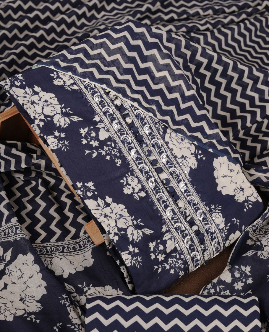 Blue colour churidar set with cream floral print, stone and thread embroidery and detailing, paired with matching pant and dupatta.