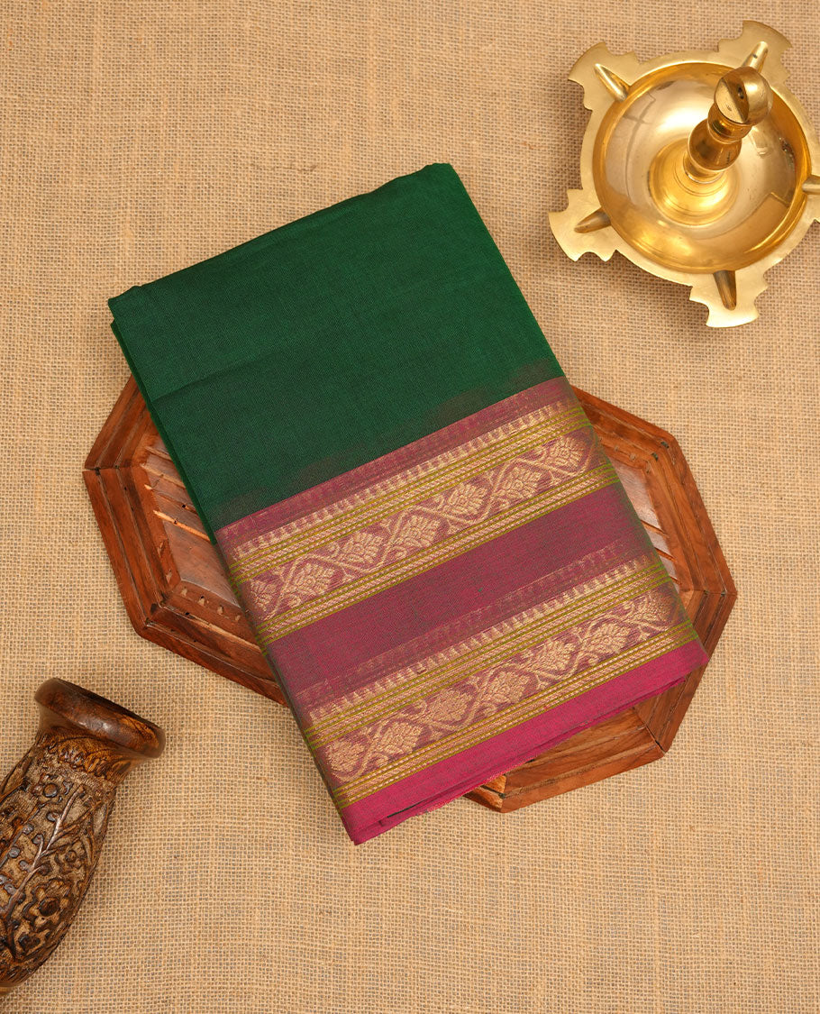 Dark green colour chettinad cotton saree featuring Elegant plain body, contrast Dusty Magenta colour border with gold zari border, pallu and paired with matching blouse.