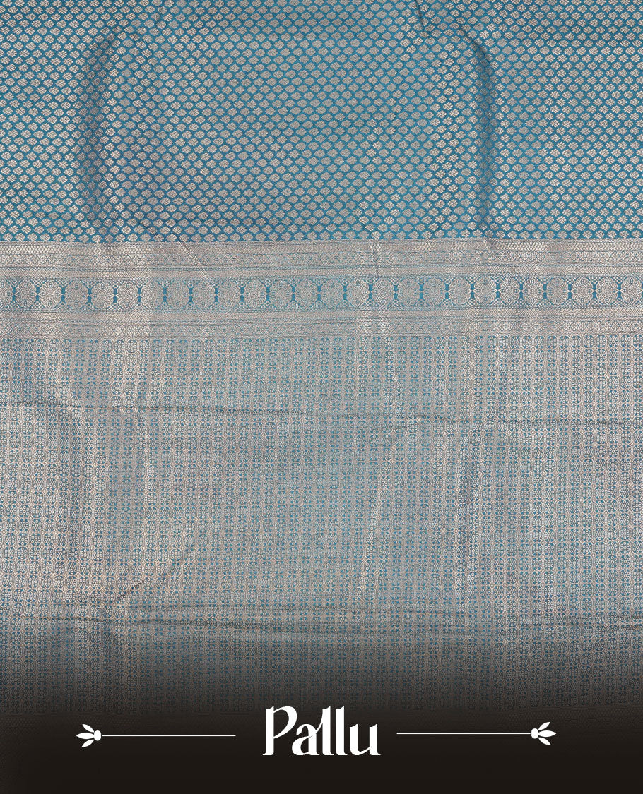 Teal colour semi silk brocade saree featuring intricate Gold patterns across the body, complemented by a Self colour woven border and pallu, paired with a matching blouse.