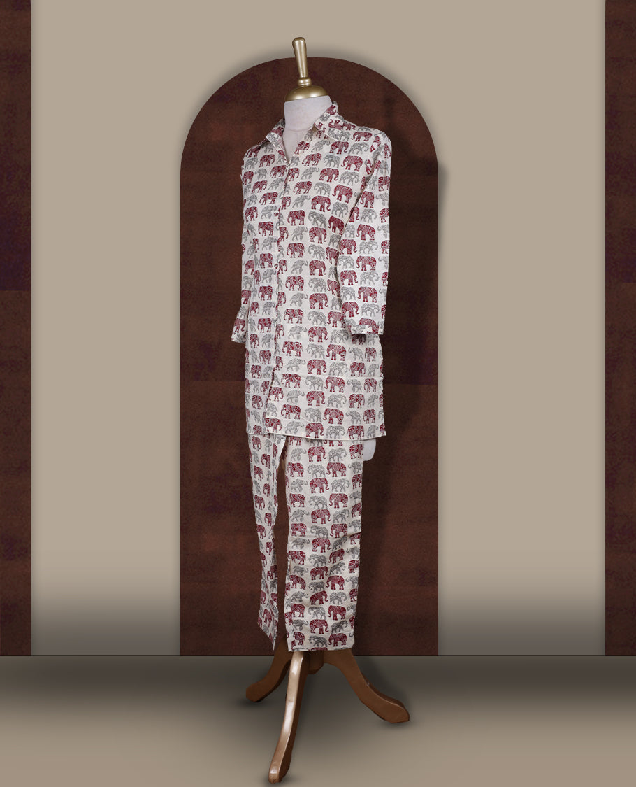 Off white colour cotton coord set featuring charming elephant prints all over, Designed with a classic shirt collar and 3/4 sleeves, paired with matching straight pants for a trendy, relaxed, and comfy everyday look.