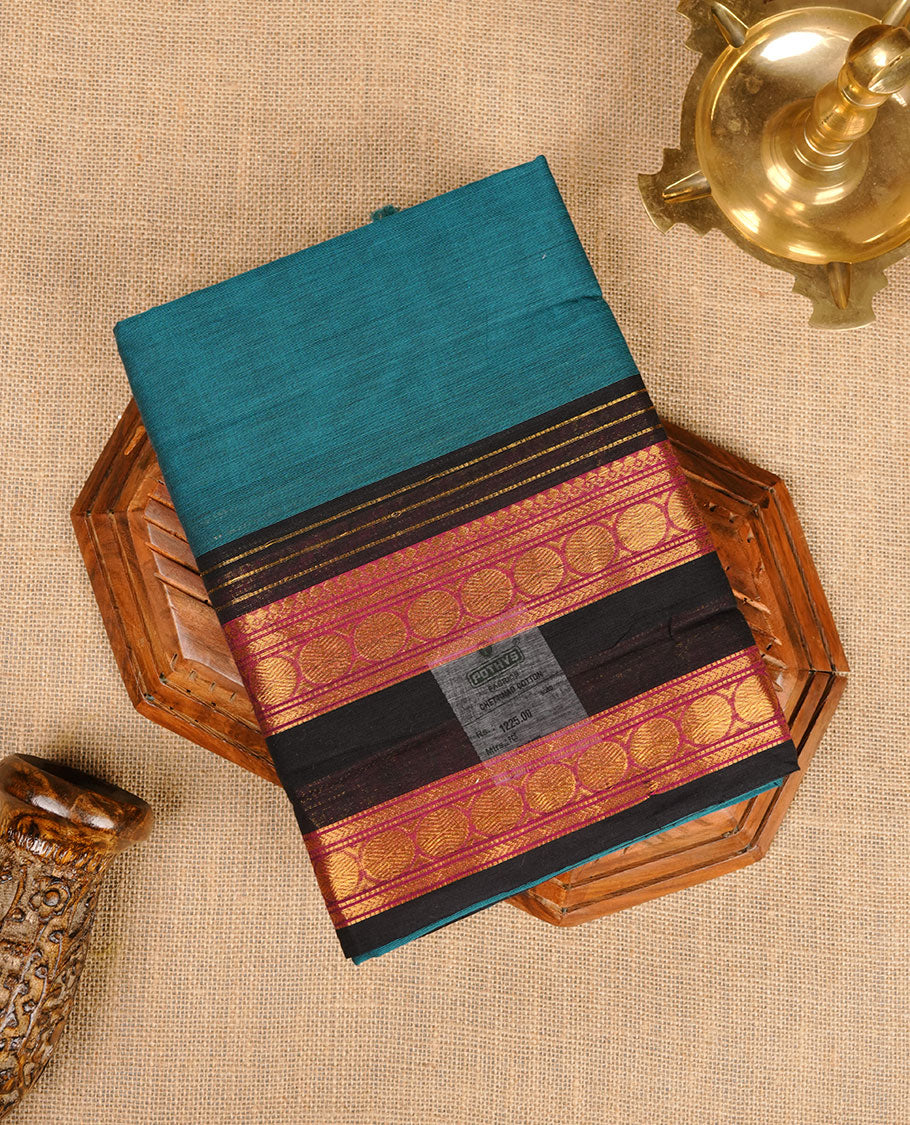 Teal colour chettinad cotton saree featuring plain body, contrast black and red colour with traditional gold zari border paired with matching blouse.