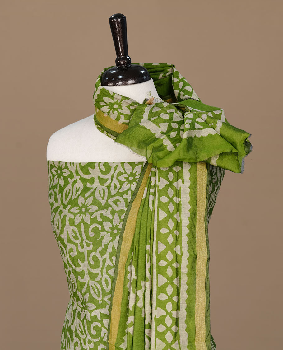 Pista green colour churidhar material featuring cream colour floral kodi print on body, paired with matching bottom and Dupatta.