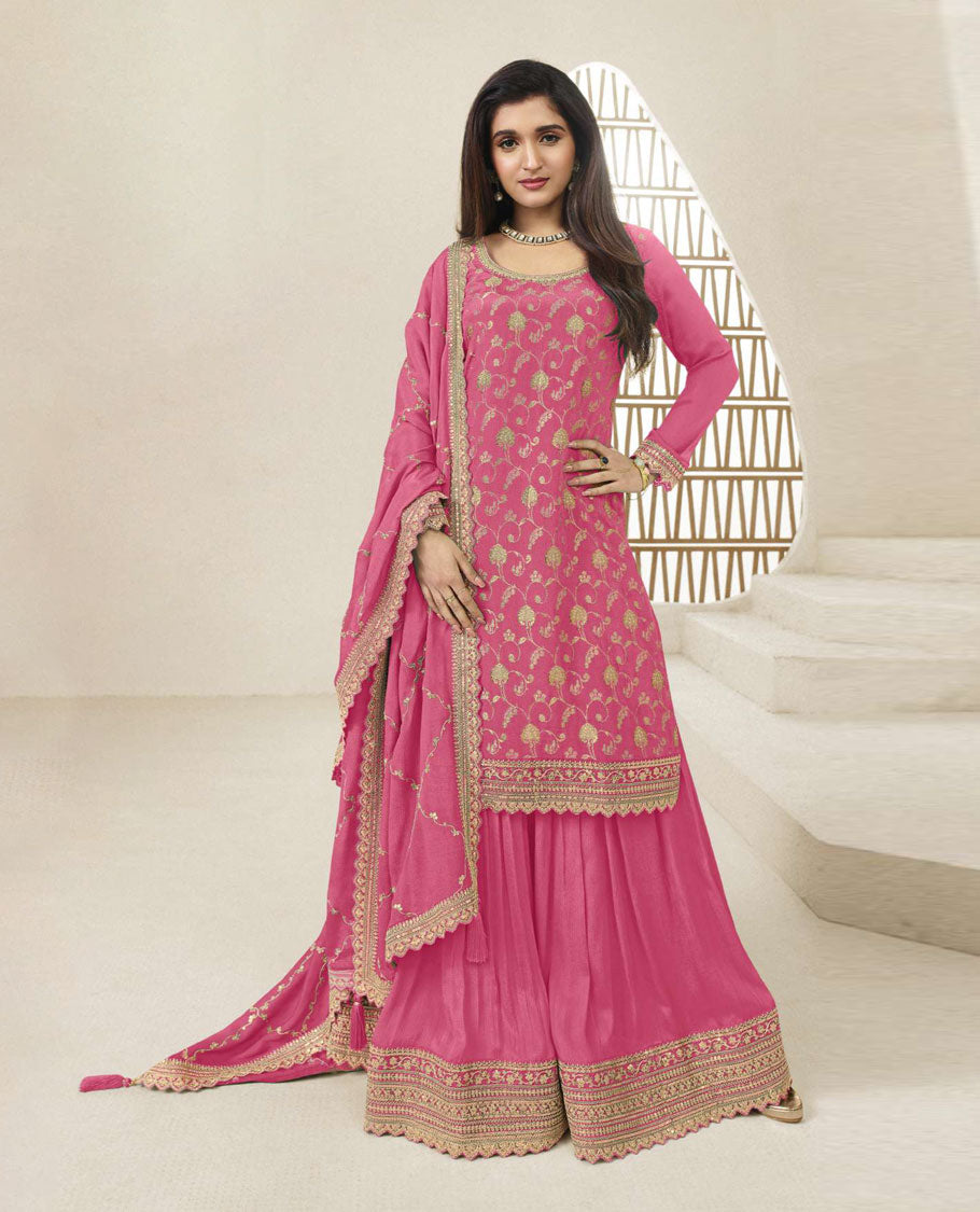Pink colour semi stitched salwar suit featuring an embroidered chinon top material paired with a matching sharara bottom, and dupatta.