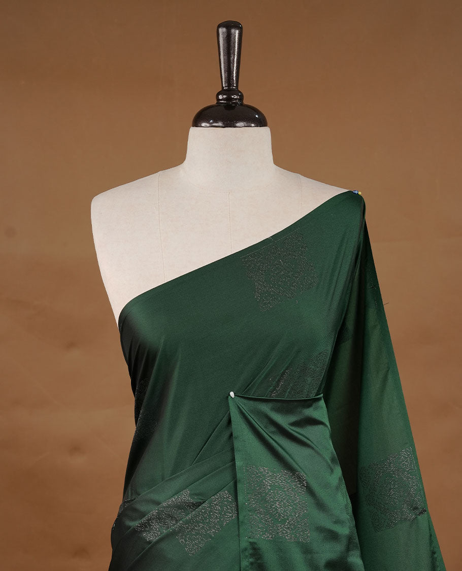 Green colour soft silk saree features a sleek borderless design with intricate antique zari motifs, flowing into a striking contrast Biscuit orange pallu and a matching blouse piece.
