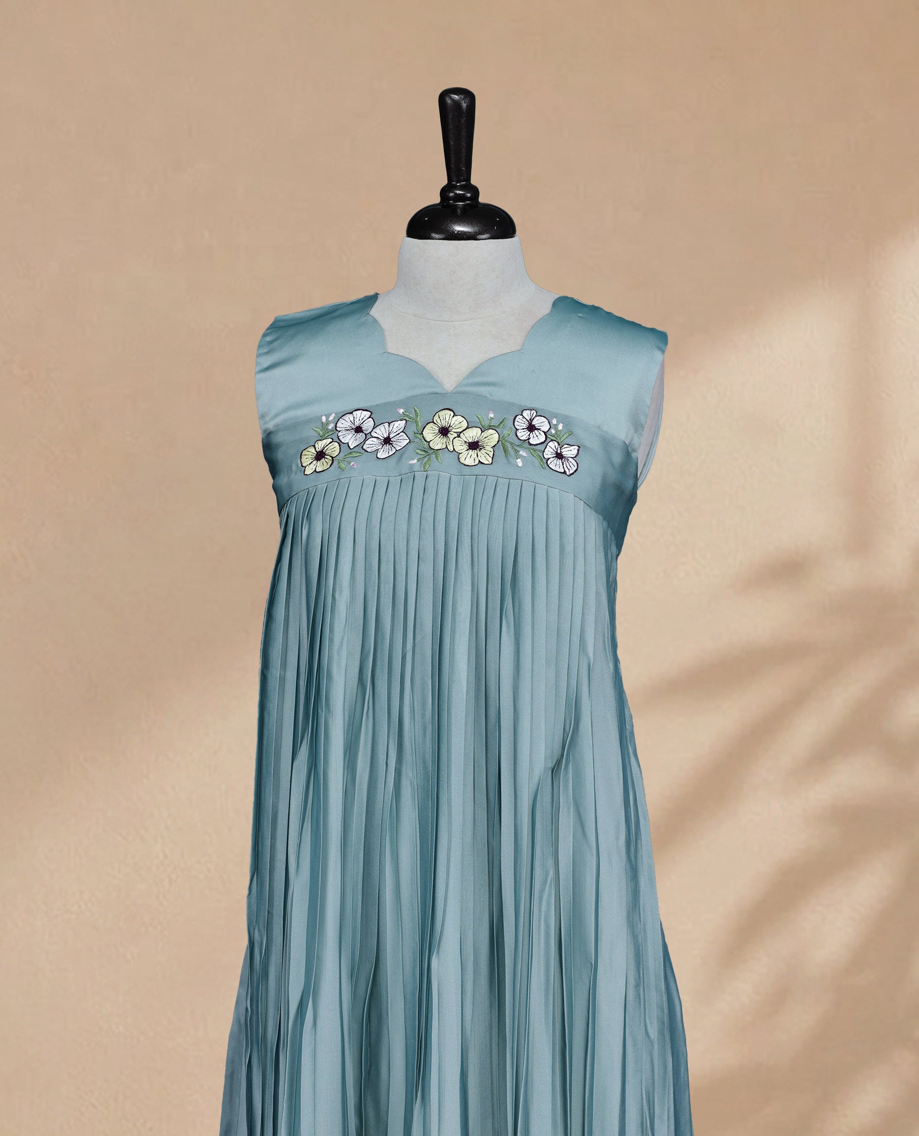 Dusty Blue Coloured Sleeveless Kurti Featuring a Designed Neckline, Floral Embroidery on the Body