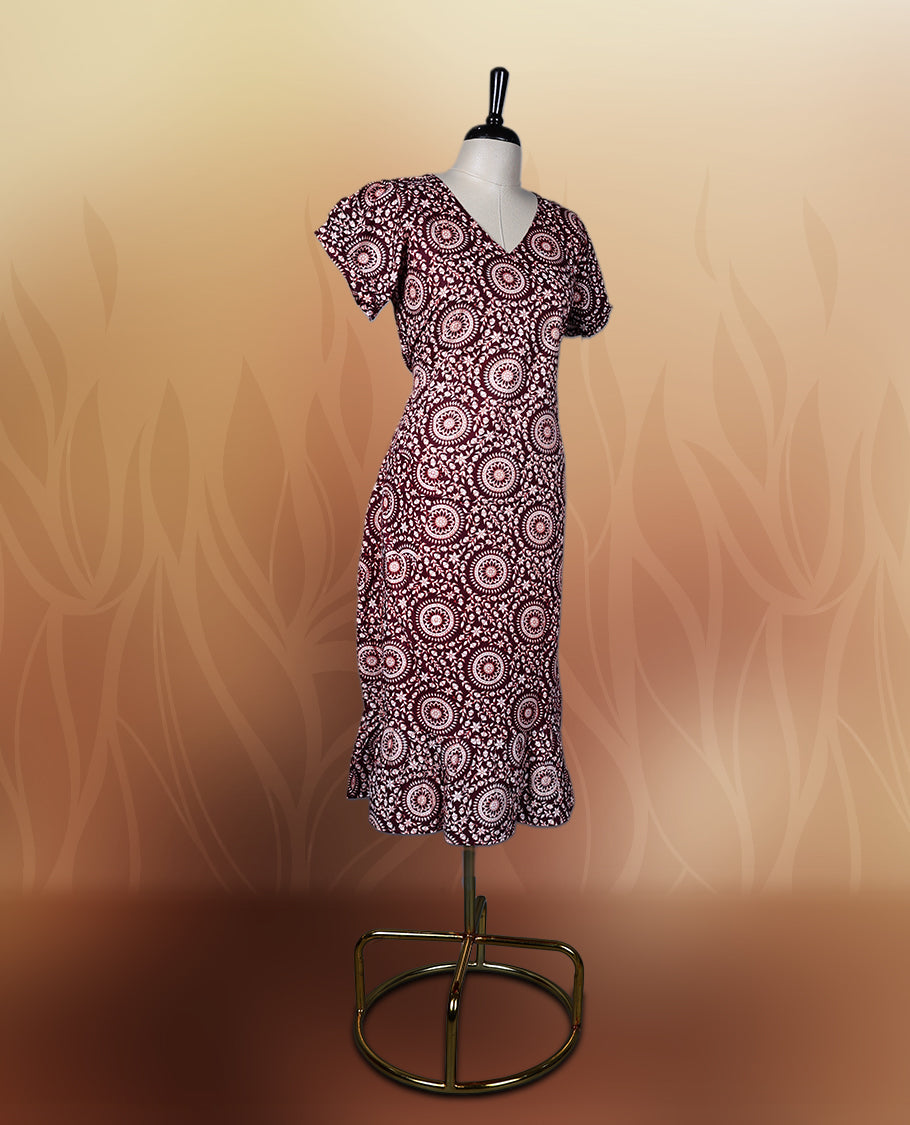 Dark maroon colour nightwear with intricate floral prints in circular patterns in beige colour, Designed with a V neckline, short sleeves, and a flared hemline. Ideal for casual outings, workwear, or ethnic inspired looks.