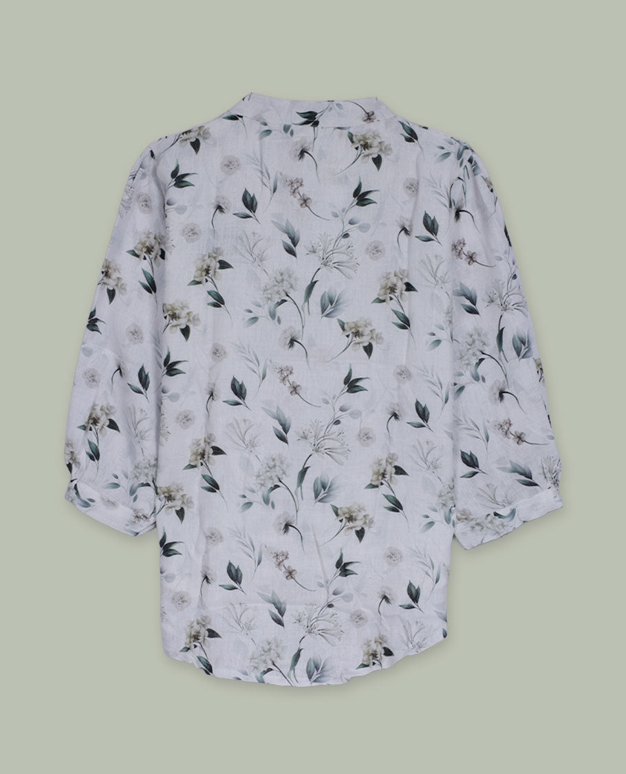White floral printed shirt top with band collar, three-quarter sleeves, and front button placket framed by intricate lace and pintuck detailing.