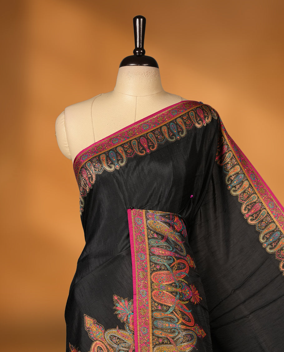 Black colour Pashmina silk saree densely woven with intricate multicolour floral and architectural motifs across the body, framed by an opulent arabesque border and grand storytelling pallu, paired with a matching black woven border blouse piece
