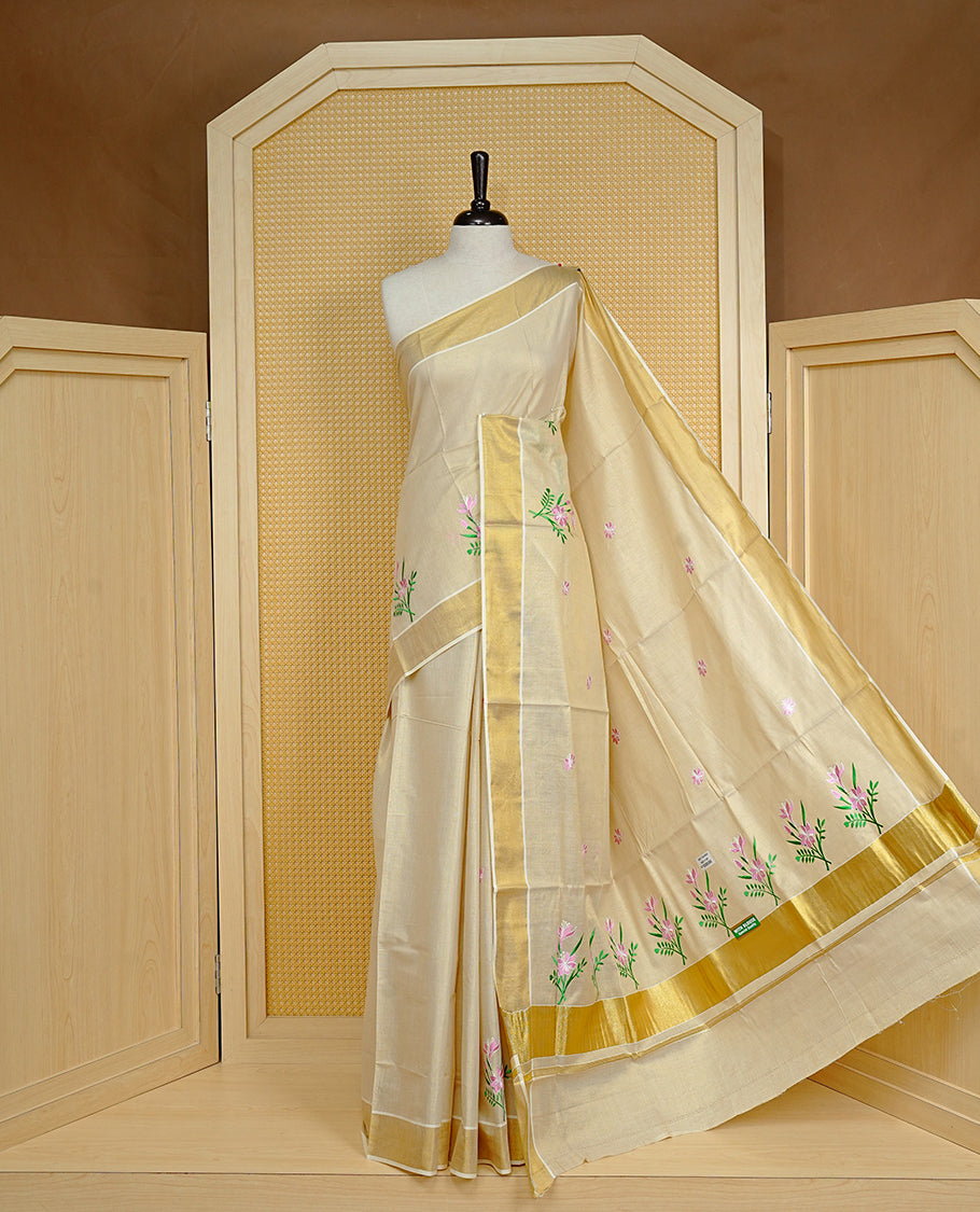 Cream colour Tissue kerala saree featuring Embroidery buttas on body, complemented by Floral plant thread work & kasavu kara, comes with matching blouse piece.