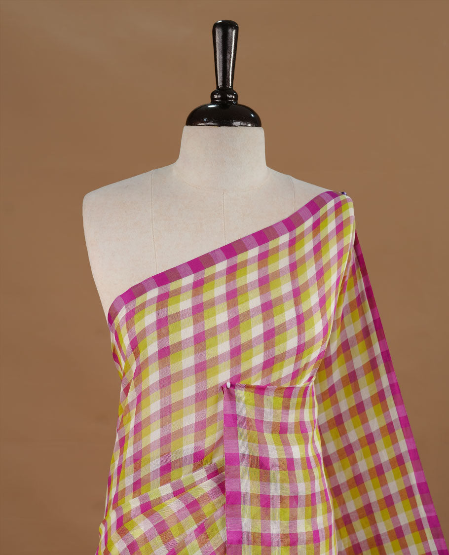 Green, Purple and White colour Mul Cotton saree featuring a classic Big check pattern on the body, accented with tassels for added charm. Comes without a blouse piece.