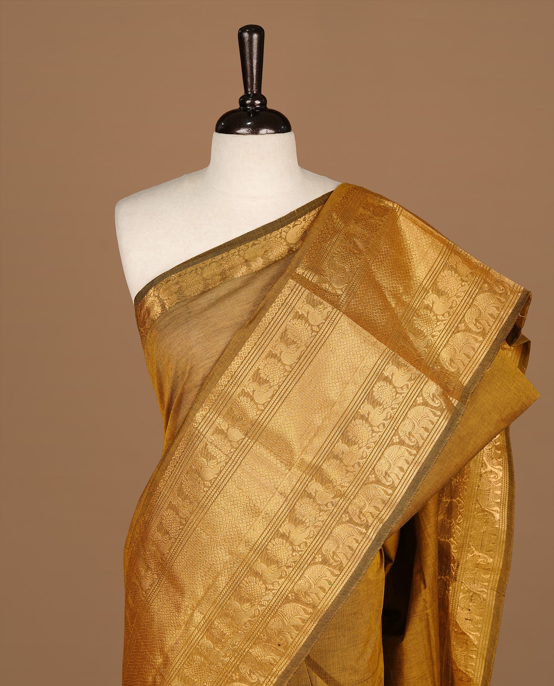 Warm Olive Colour chettinad cotton saree featuring Elegant plain body, complemented by self colour with gold zari border, paired with matching blouse.