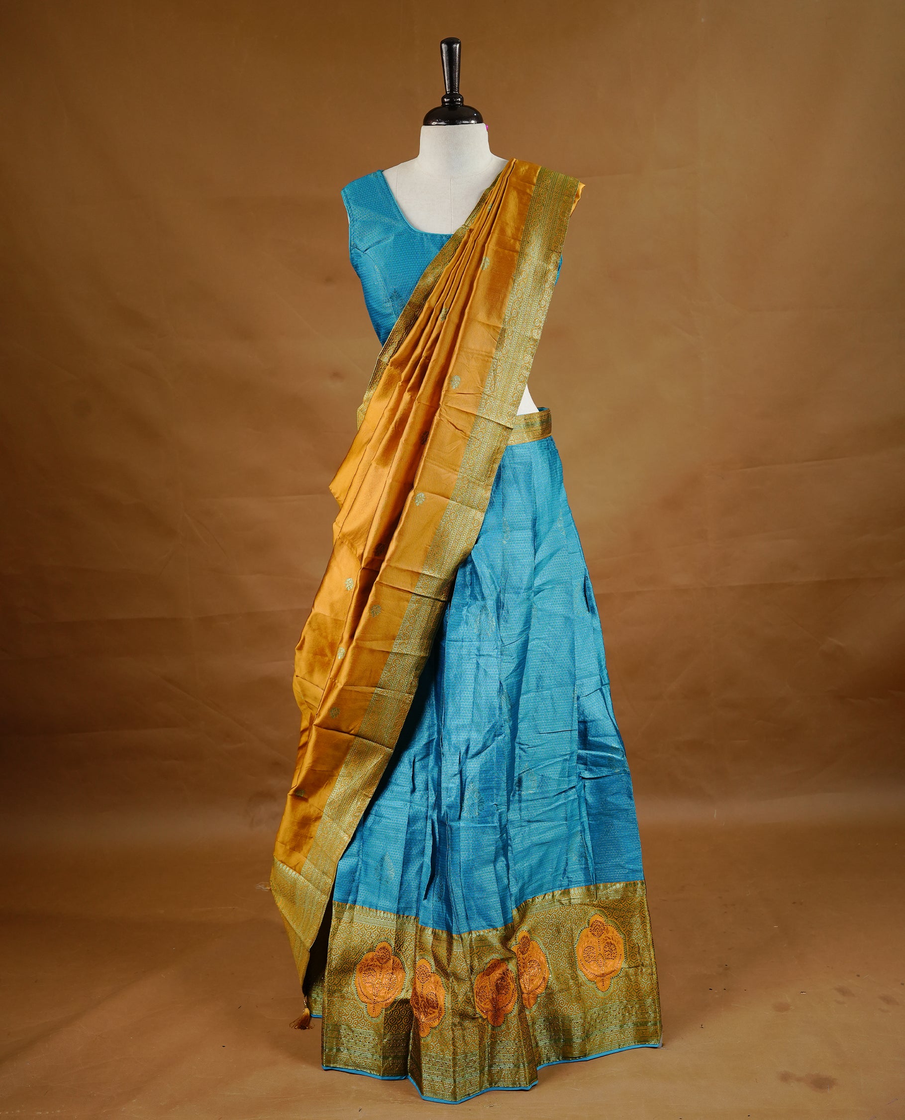 Blue colour Half saree featuring a blue colour skirt with contrast mustrad colour border with zari pattern,stone work, paired with matching dupatta, stitched blouse.