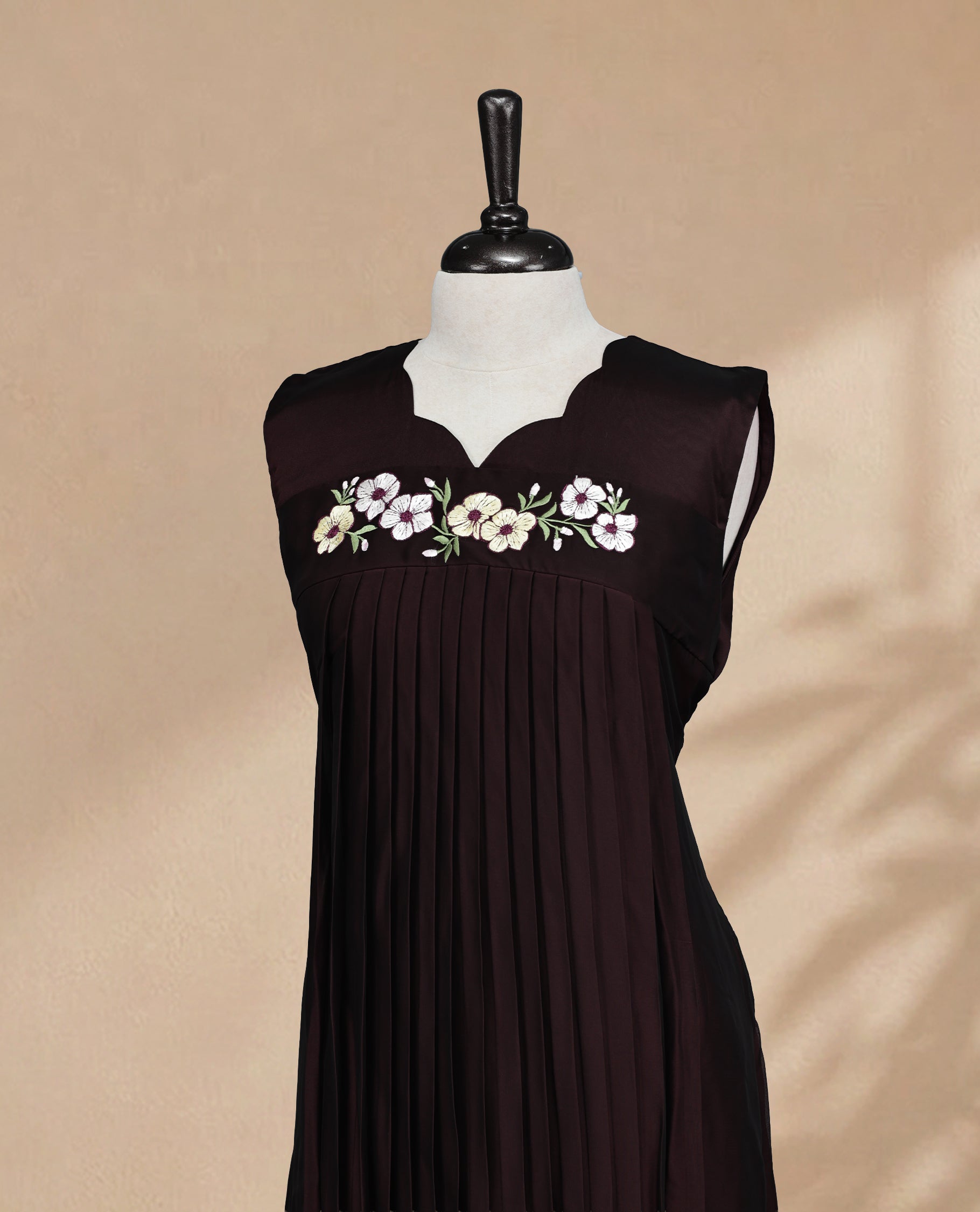 Dark Chocolate Coloured Sleeveless Kurti Featuring a Designed Neckline, Floral Embroidery on the Body