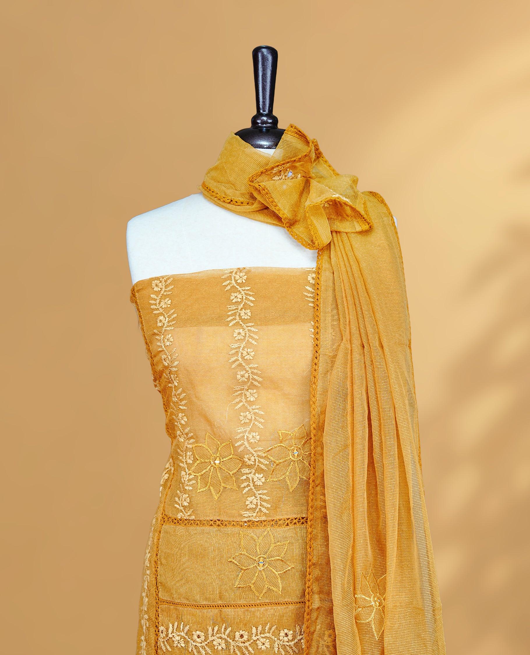 Mustard colour Salwar material featuring Self colour Floral Thread pattern, Matching bottom and paired with Same colour with thread patterned Dupatta.