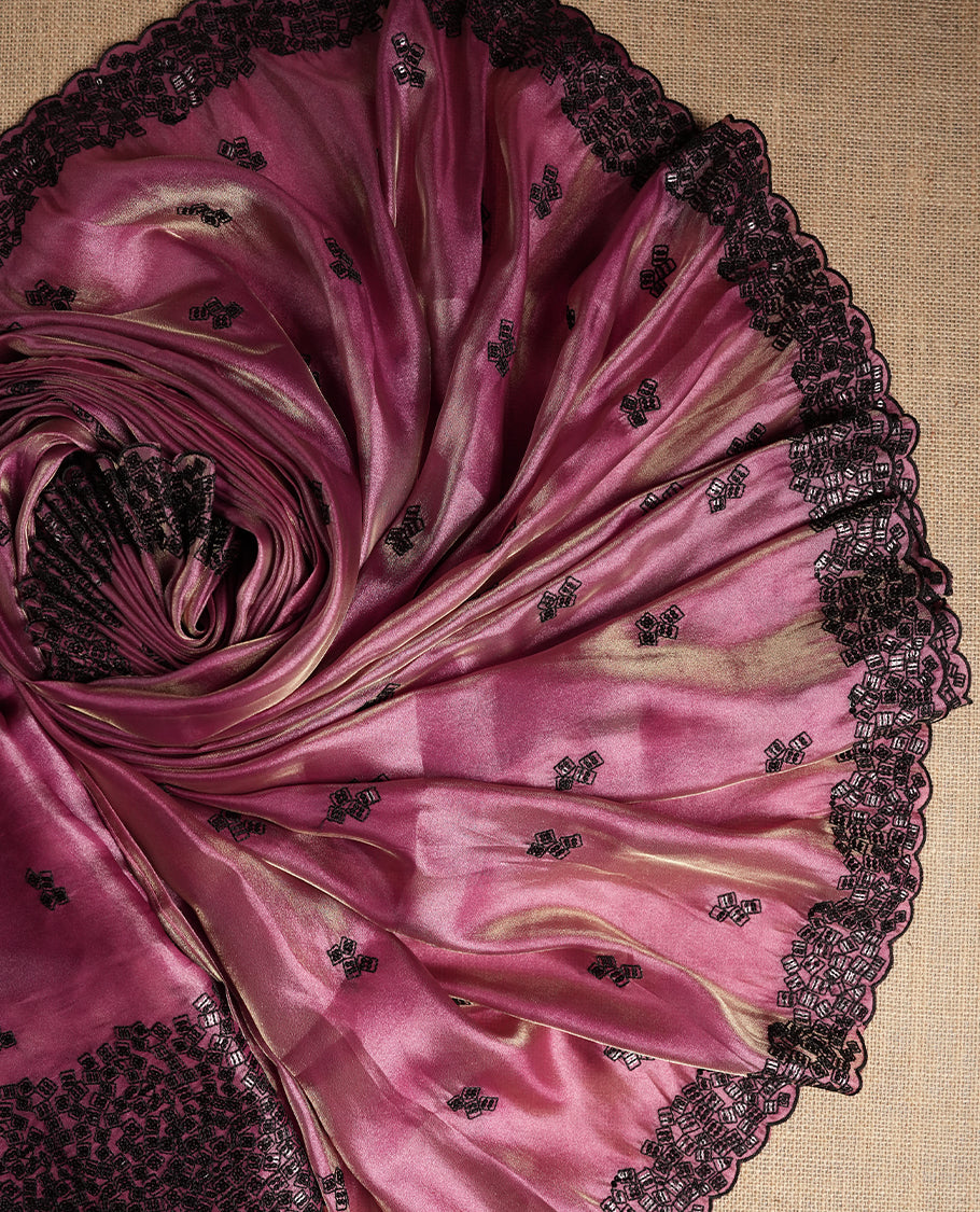 Charming mauve colour dual shaded suit material featuring intricate black thread and sequin embroidery with a delicate lace border, Paired with a matching embroidered dupatta and plain bottom.