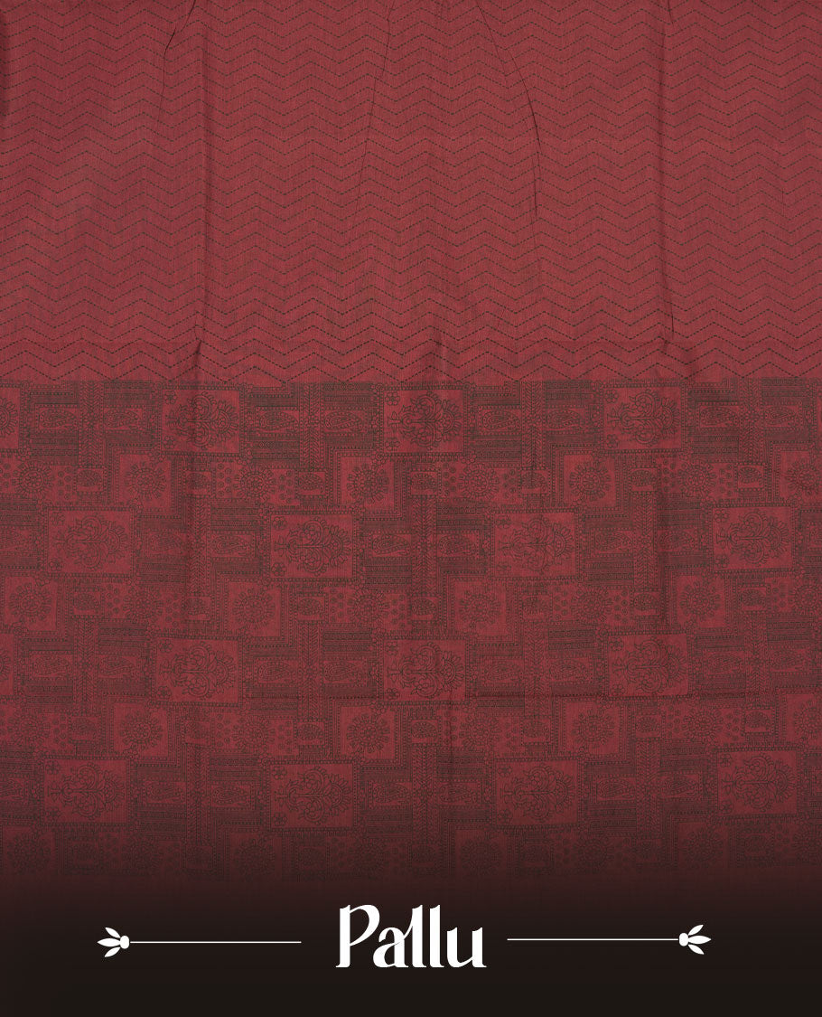 Deep Maroon colour poly cotton saree with black zigzag line pattern on the body, paired with a matching pallu featuring black chevron lines and panelled floral‑paisley design, and a coordinated all‑over floral paisley patch‑style printed blouse piece.