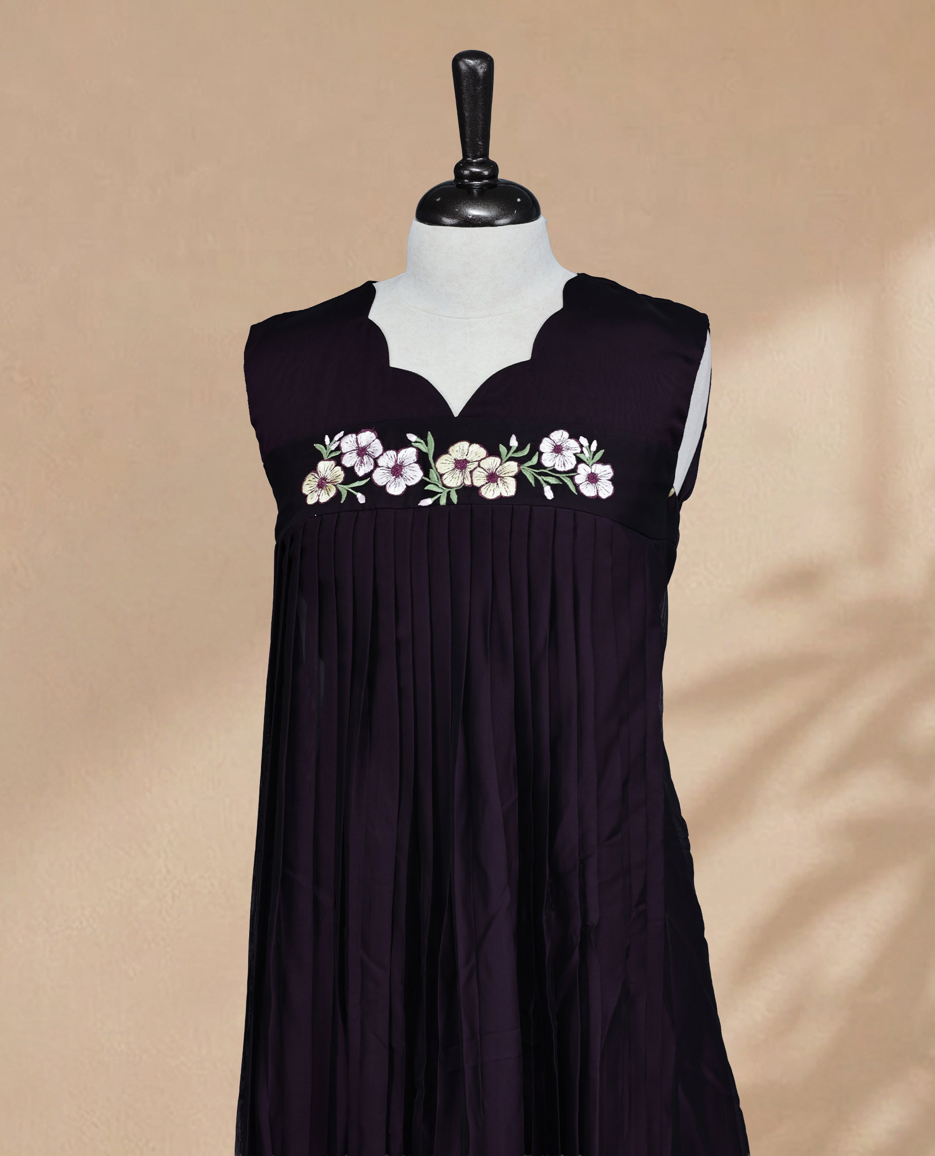 Deep Purple Coloured Sleeveless Kurti Featuring a Designed Neckline, Floral Embroidery on the Body