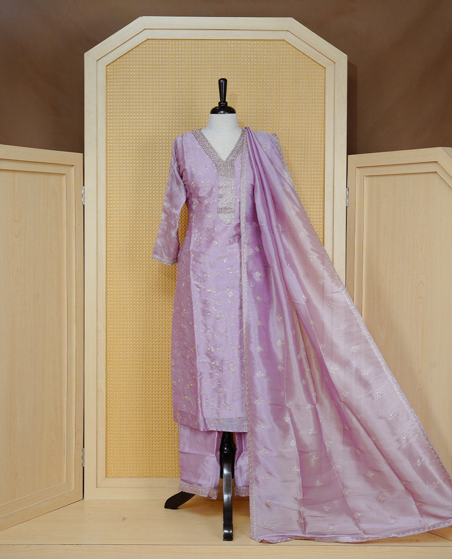 Lavender colour churidar set with delicate thread and sequin floral embroidery, an embellished V-neckline, paired with a matching embroidered dupatta and solid pants.