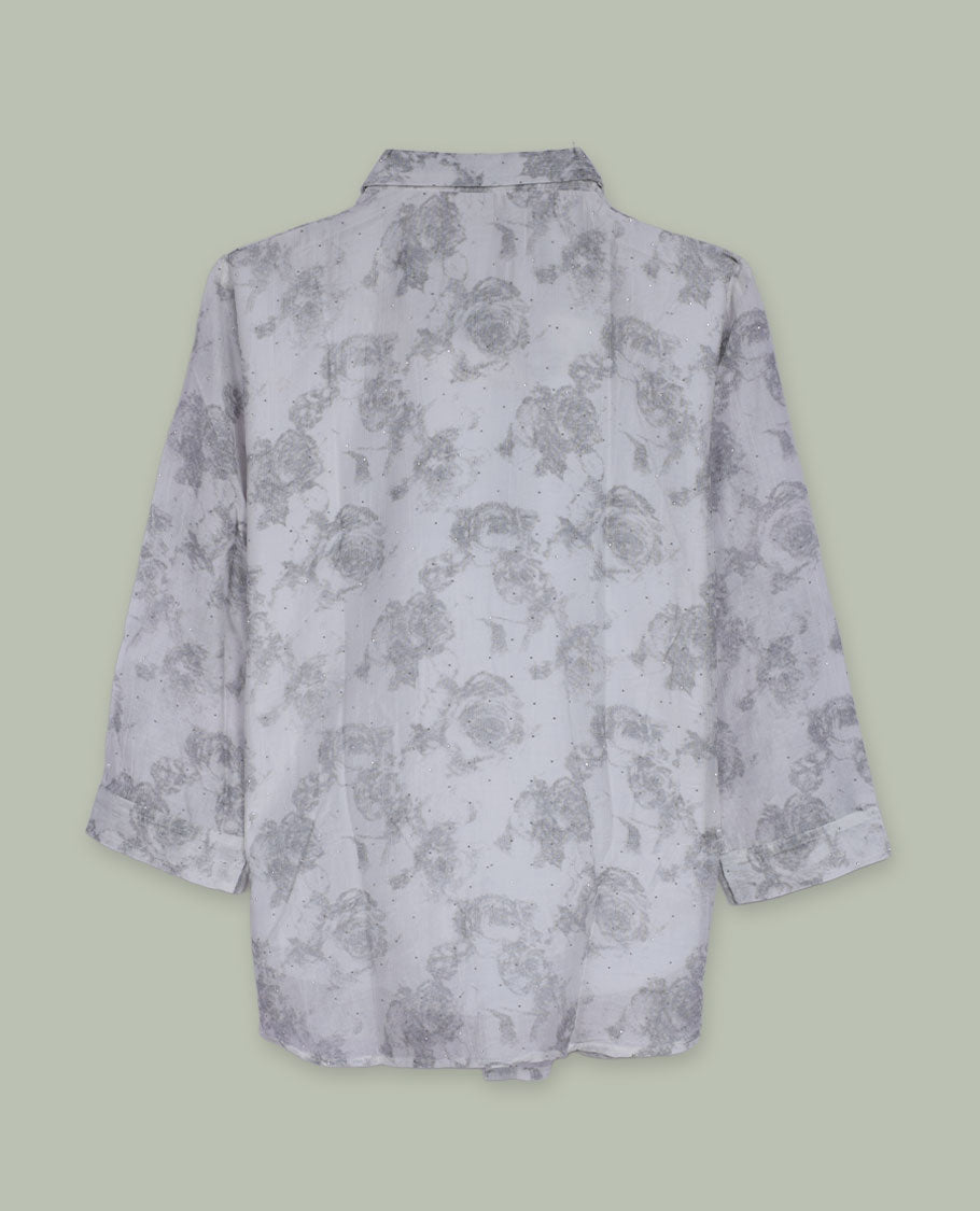 White longline floral printed shirt with collared neckline, full front button placket, long sleeves, and subtle all-over grey rose motifs.