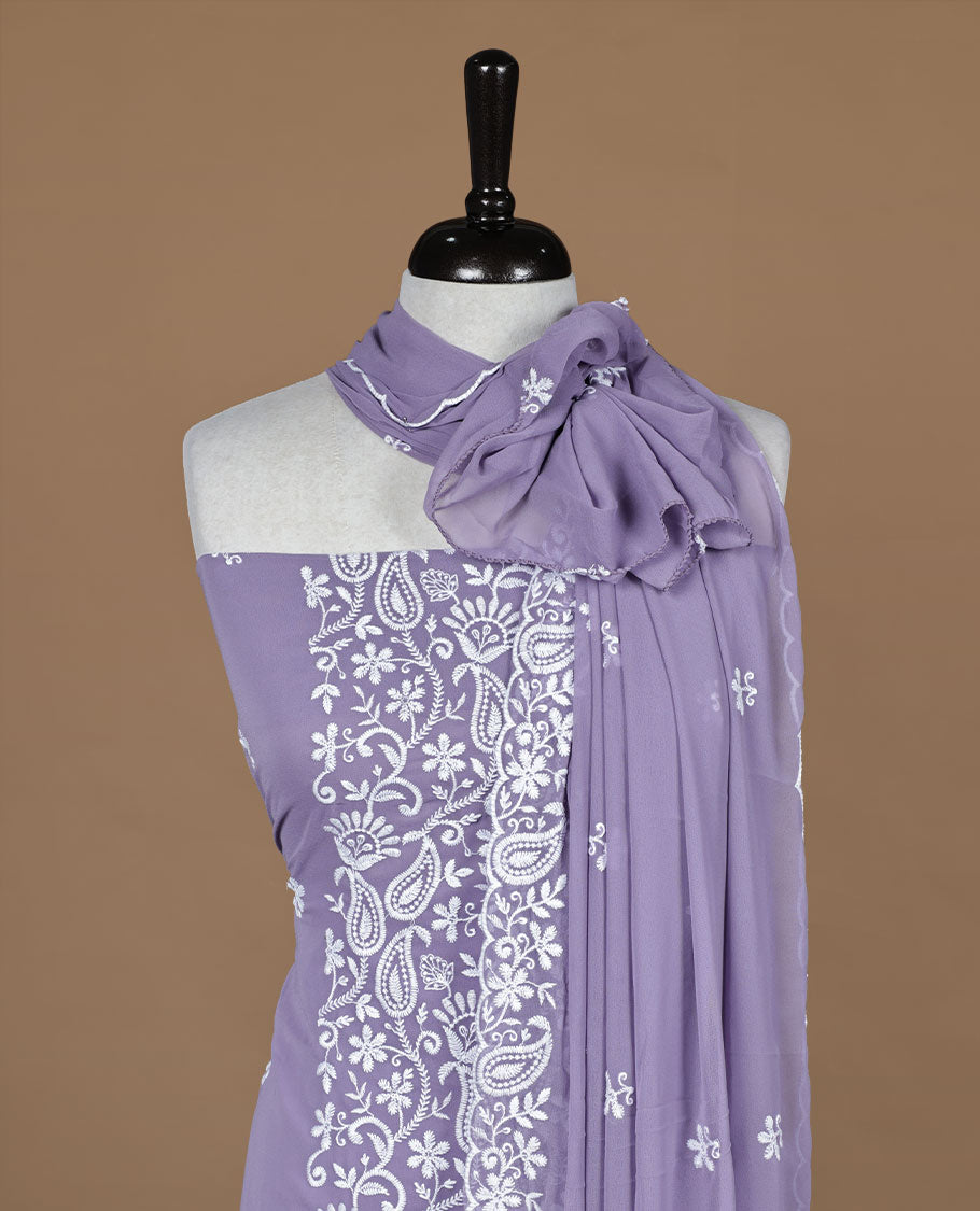 Lavender colour churidar material featuring white thread floral pattern on body, paired with matching bottom and dupatta.