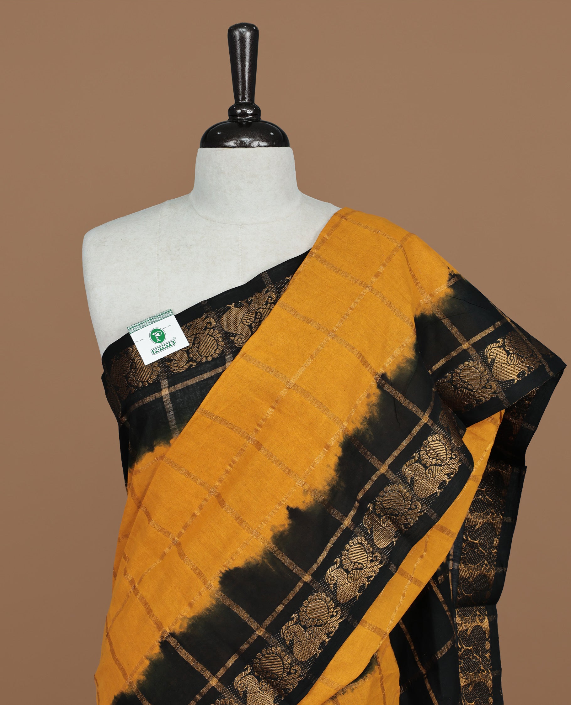 Mustard colour Sungudi cotton saree featuring Gold zari Check pattern on body, Gold zari Peacock design on Dyed Black colour design border, paired with matching blouse piece.