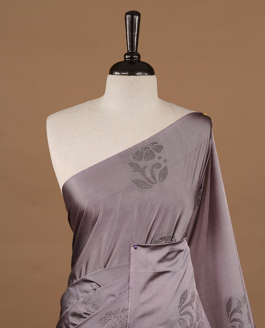 Lavender colour soft silk saree features a sleek borderless design with intricate antique zari motifs, flowing into a striking contrast maroon pallu and a matching blouse piece.