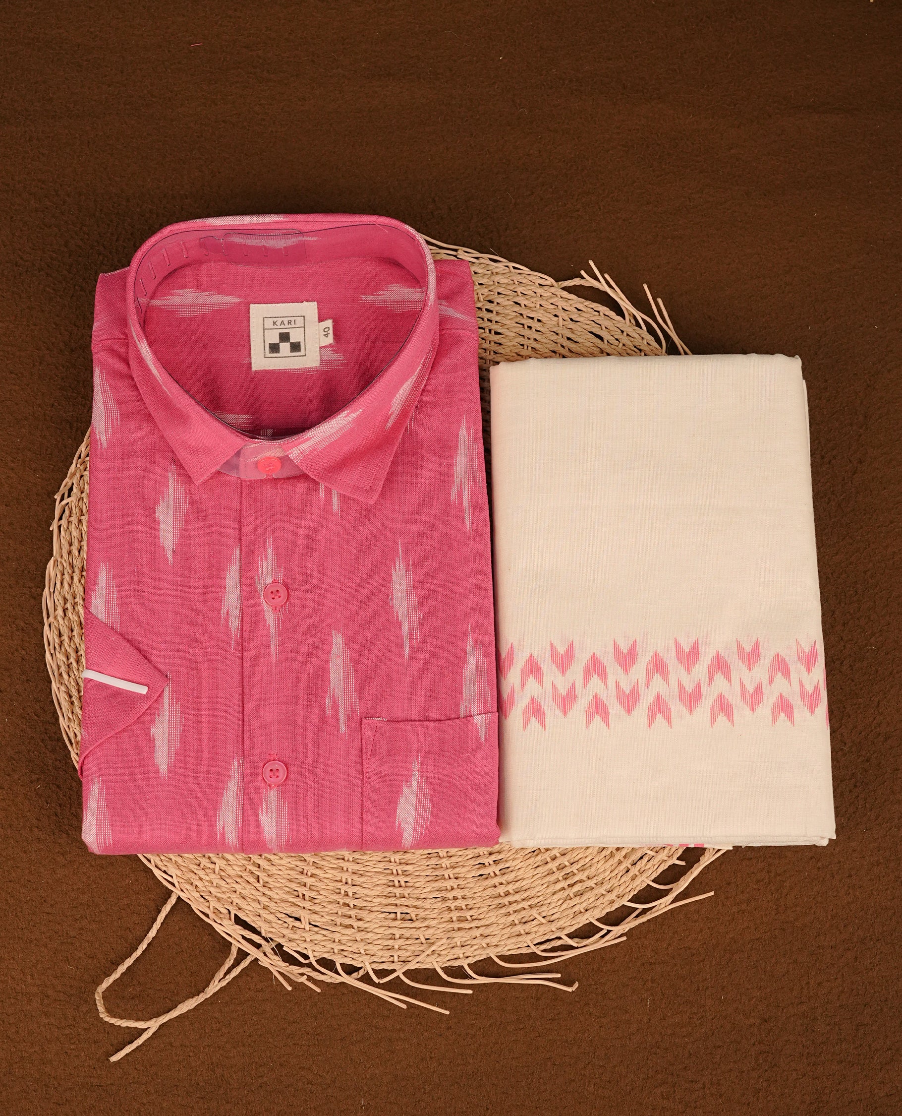 Pink colour shirt featuring Floral Pattern printed body, paired with cream colour double dhoti featuring Arrow printed border.
