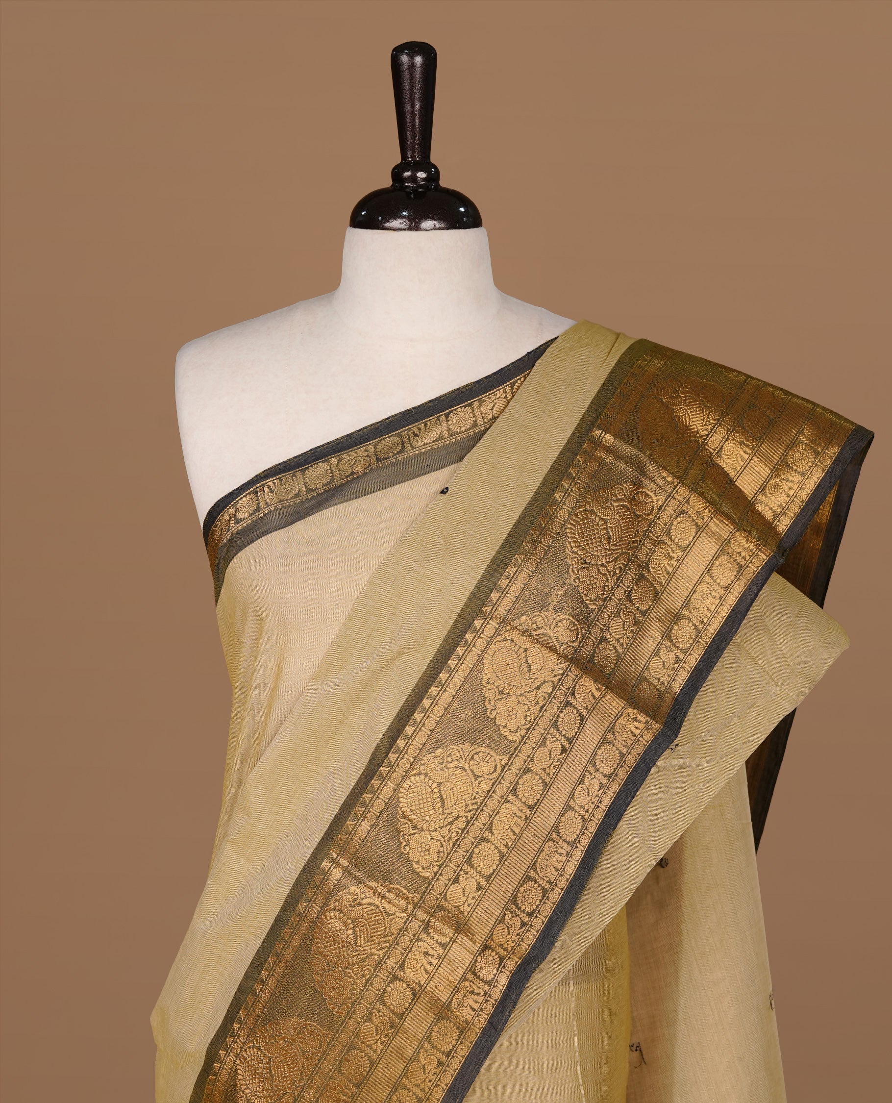 Grey beige colour Chettinad cotton saree featuring motifs on body , complemented by contrast Black colour with zari border, comes with matching blouse piece.