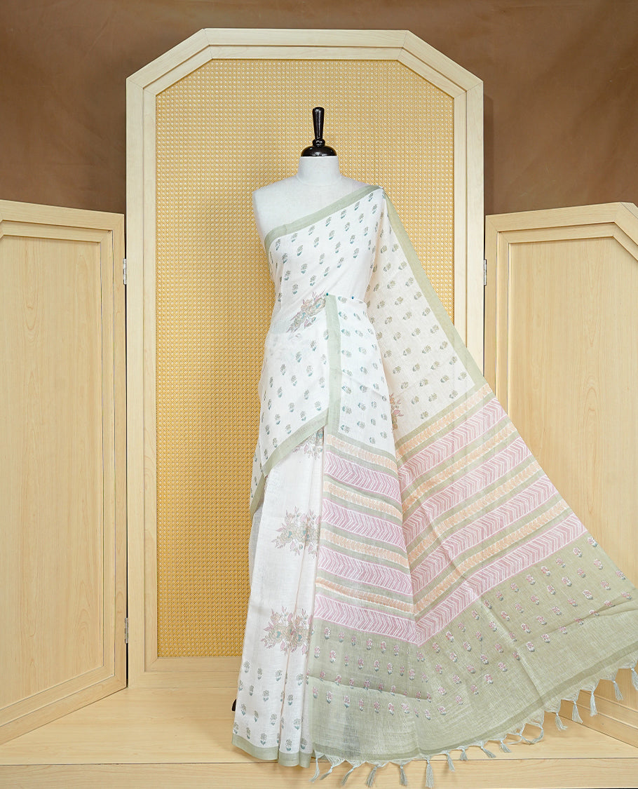 Cream colour semi linen saree featuring Light green colour floral print on body, complemented by contrast Light purple border, comes with matching blouse piece.