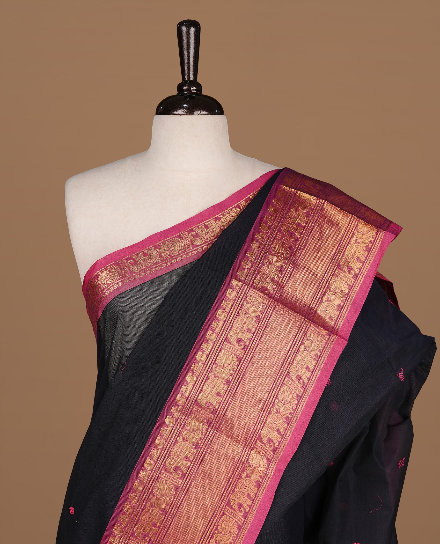 Black colour Chettinad cotton saree featuring motifs on body , complemented by contrast Magenta colour with zari border, comes with matching blouse piece.