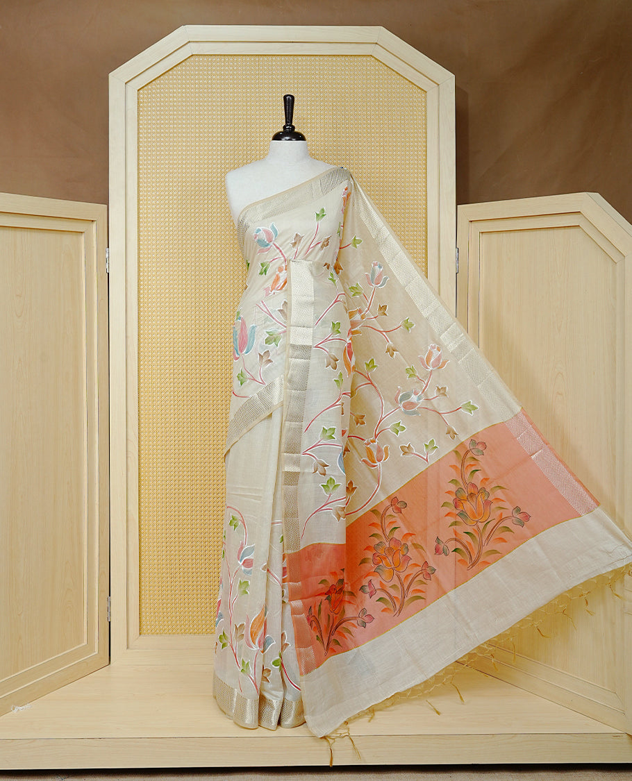 Cream Colour Tissue Kerala Saree Featuring Floral Kodi Threadwork Across The Body, Enhanced With A Light Gold Zari Border And A Peach Floral Pallu, Finished With Gold Tassels And A Matching Blouse Piece