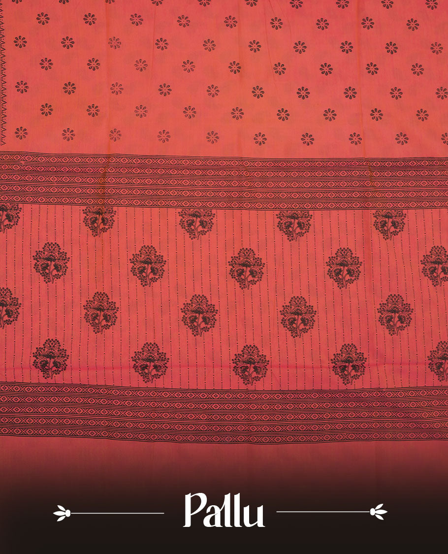 Peach Orange colour poly cotton saree with black floral butti motifs on the body, paired with a matching pallu featuring black ornate floral jaal and stripes on the border, and a coordinated all‑over black paisley printed blouse piece.