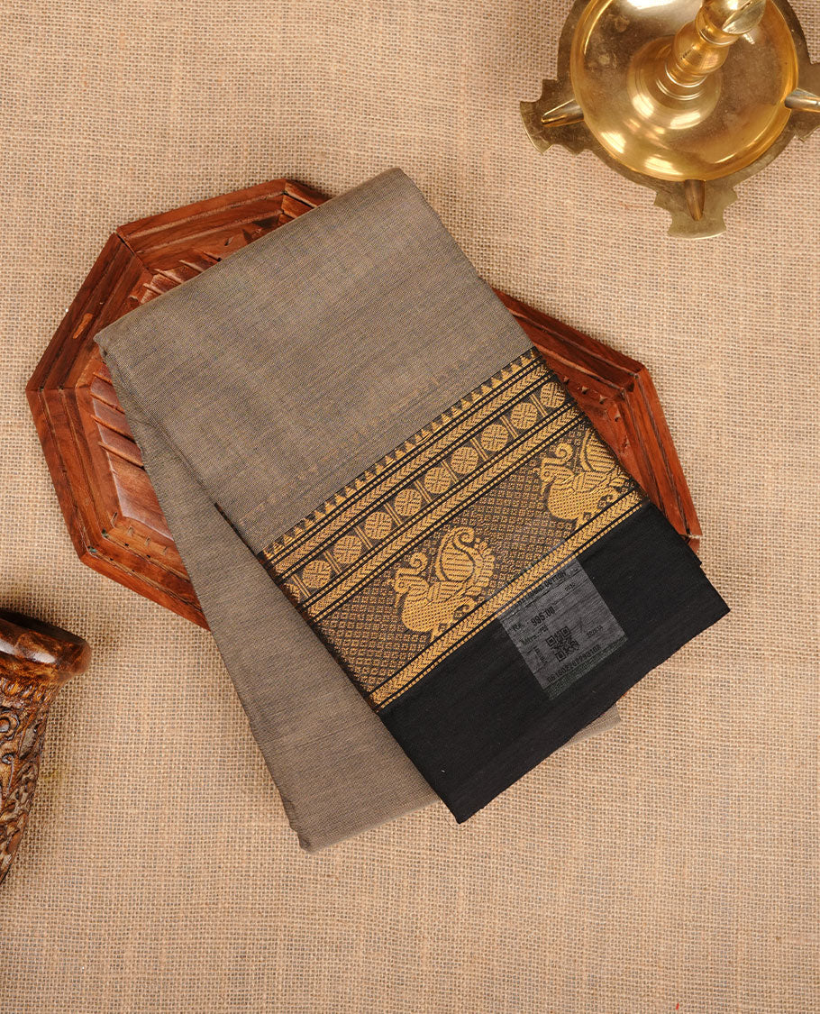 Beige grey colour chettinad cotton saree featuring plain body, contrast black colour with traditional gold zari border without blouse.