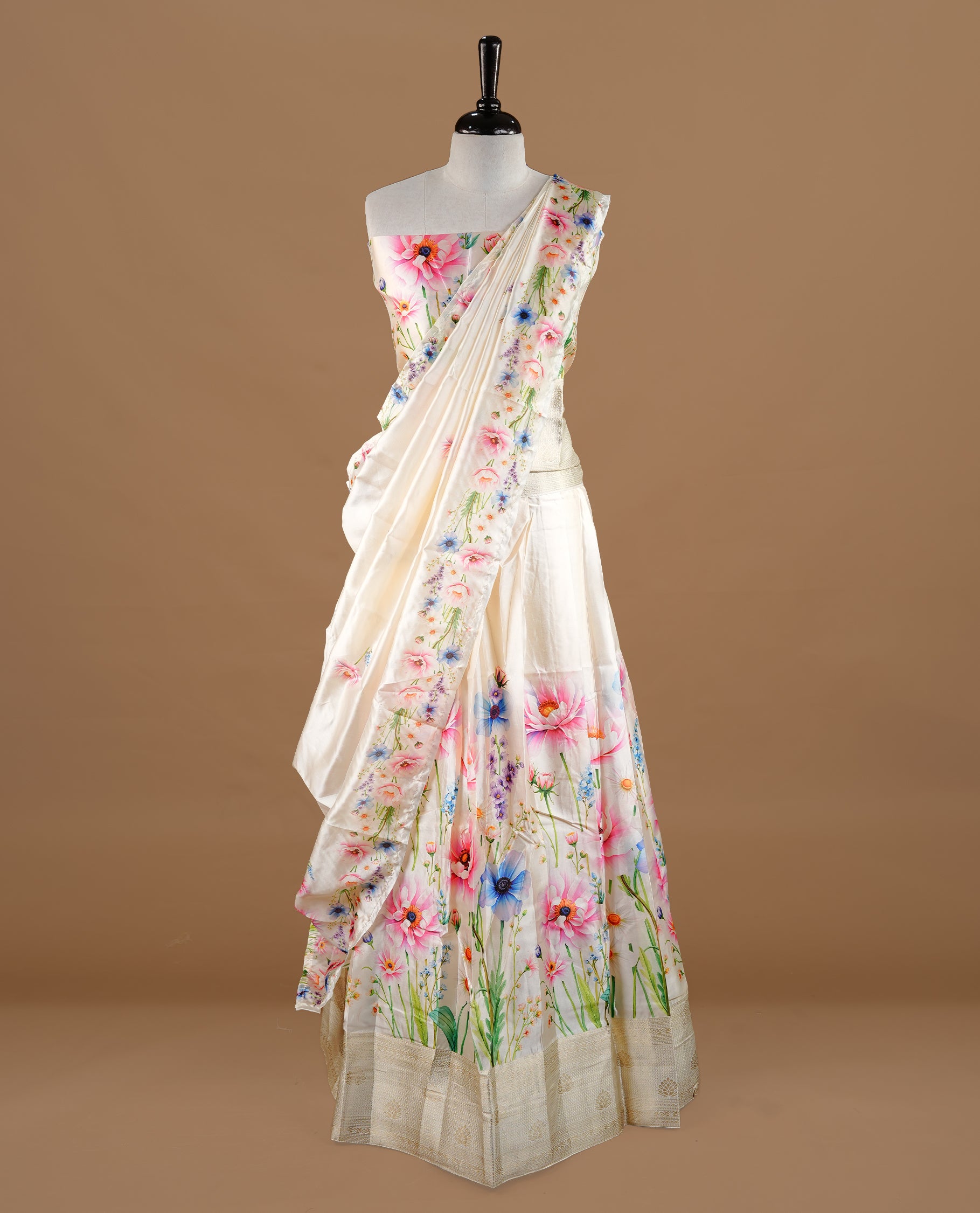Off white colour semi stitched half saree featuring elegant pink colour floral prints, paired with a cream with traditonal zari border and matching printed dupatta ,paired with matching blouse piece.