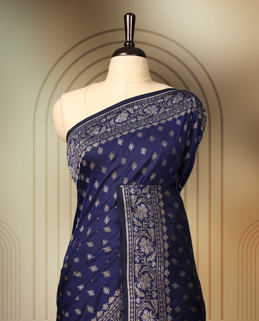 Graceful navy blue Banaras soft silk saree with gold zari buttas on the body, intricate floral zari border, grand pallu with paisley motifs, and a matching blouse. Perfect for weddings and celebrations.
