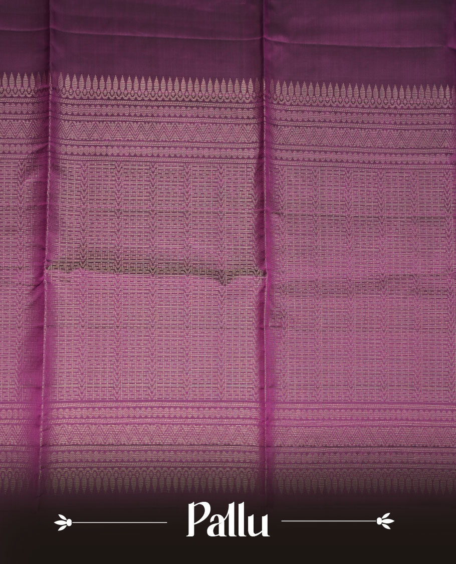 Purple colour soft silk saree featuring gold zari motifs on body, complemented by self colour with traditional border with tassel at pallu, paired with matching blouse piece.