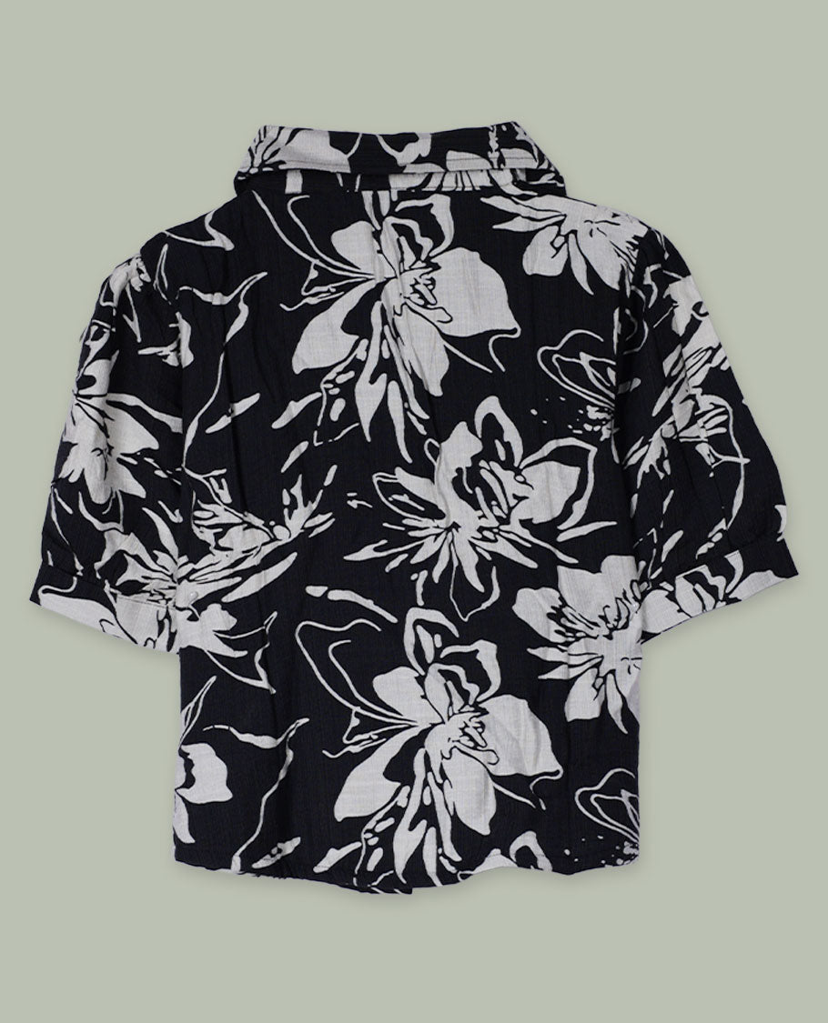 Black and white floral printed short-sleeve shirt top with collared neckline, front button placket, and softly gathered shoulders.