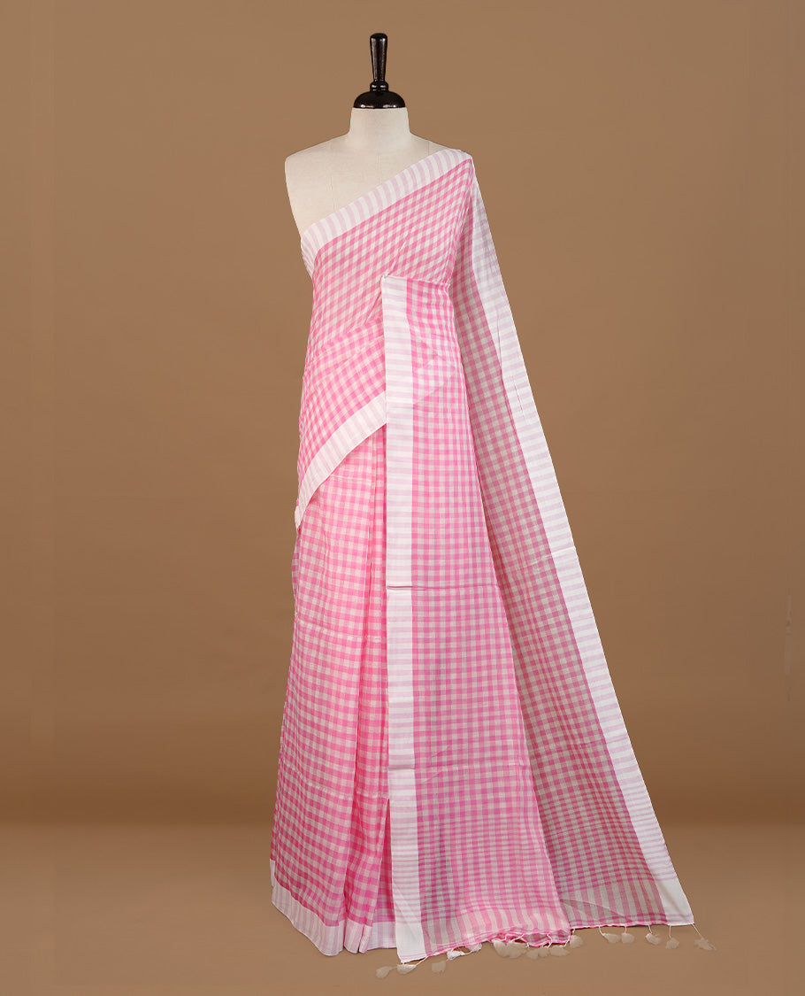 Pink and White colour Mul Cotton saree featuring a classic Big check pattern on the body, accented with tassels for added charm. Comes without a blouse piece.
