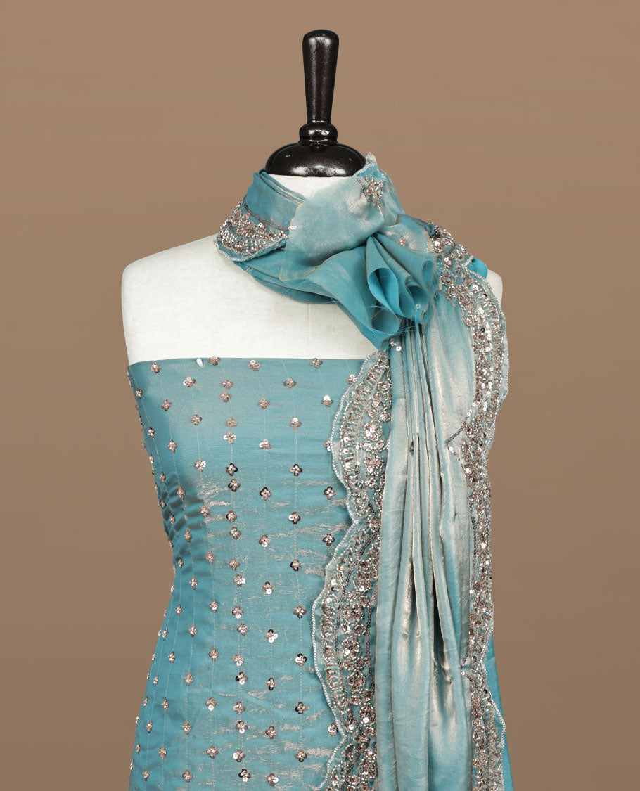 Sky blue colour churidhar material featuring cut beads and sequins work on the body, paired with a matching unstitched bottom and worked dupatta.