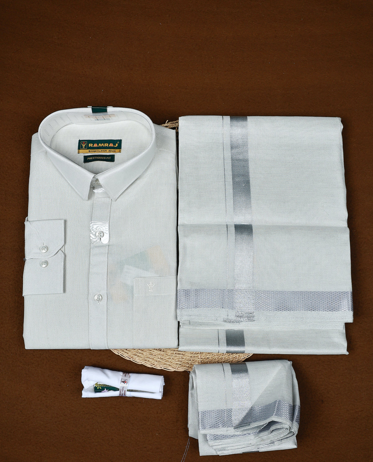 Silver colour RAMRAJ Tissue Shirt paired with a matching dhoti, finishing with a Silver kara