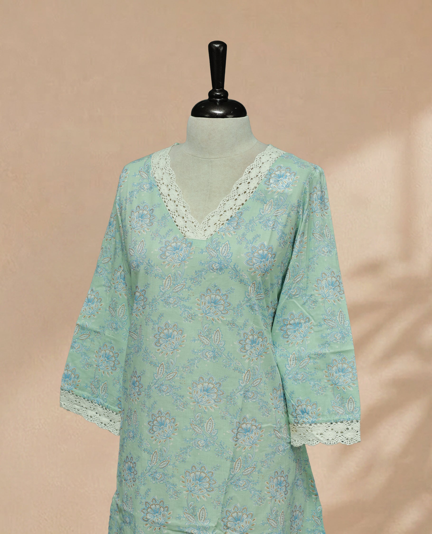 Mint Colour kurti featuring a classic V-shaped Laces neckline, Floral Pattern on the body, Comes With sleeves.