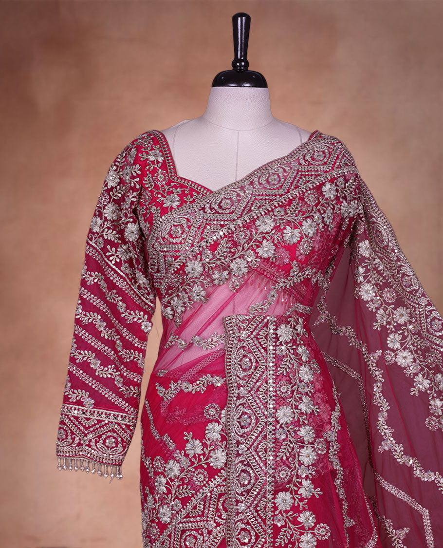 Rani Pink Colour net designer Wedding saree featuring all over floral embroidery with sequin detailing and an ornate scalloped border, finished with a matching embellished blouse.