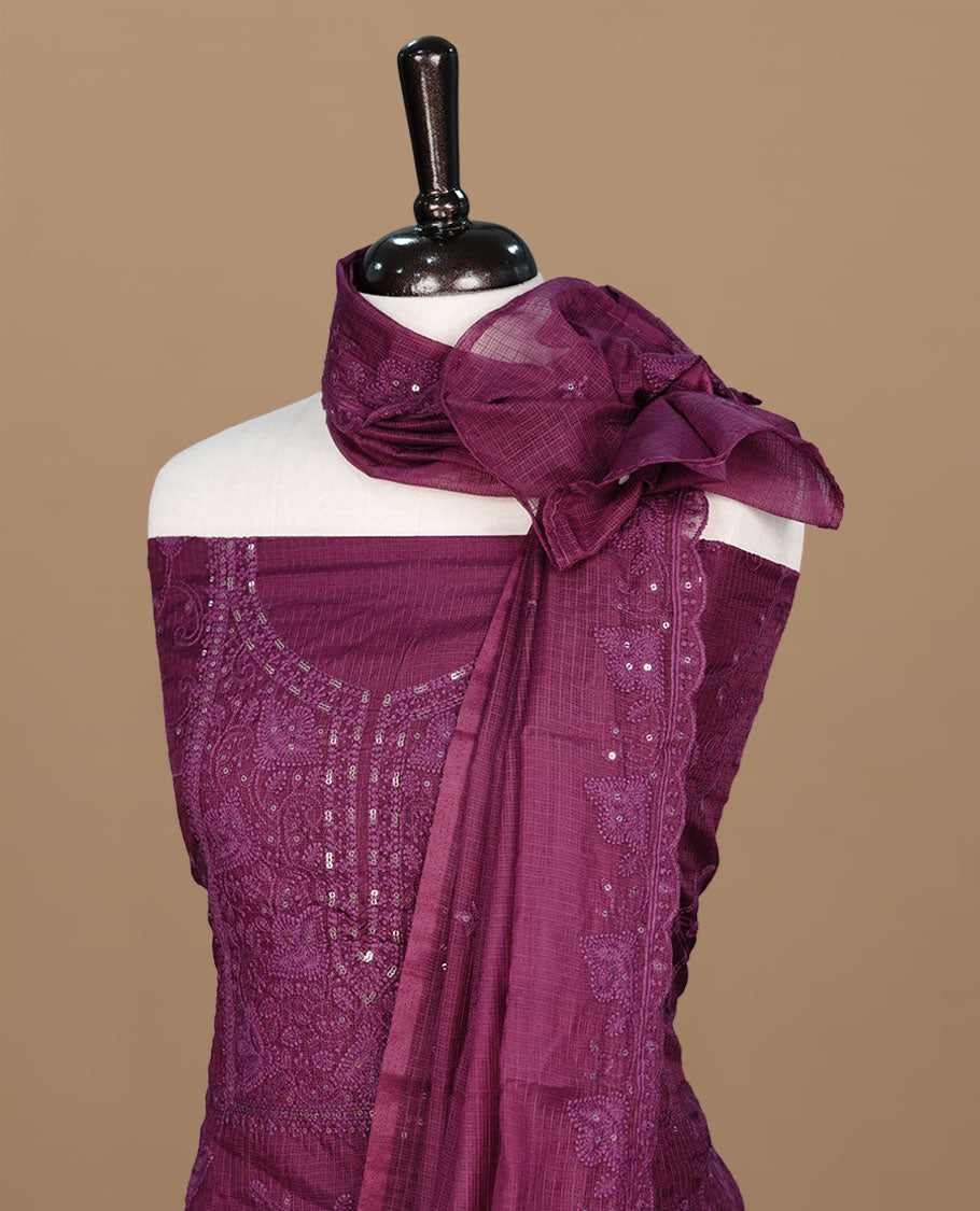 Wine colour churidar material featuring self colour thread and sequins on body and neckline, paired with matching bottom and dupatta