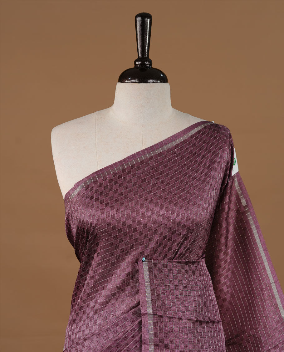 Onion colour Semi Tussar saree featuring an elegant zari fancy check pattern on the body, highlighted with a small border for a refined look. Comes without a blouse piece.