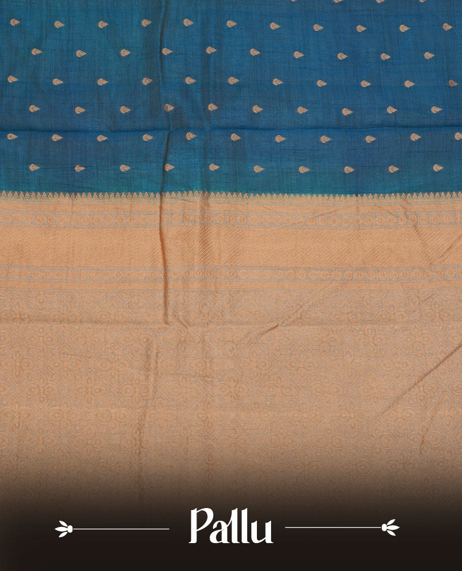 Teal colour semi tussar saree featuring gold zari buttas across body, contrast grey colour gold zari border and comes with matching blouse piece.