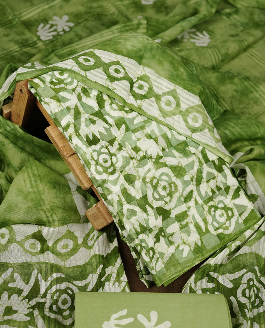 Green colour churidar material featuring white floral printed body, paired with a matching chevron printed dupatta.