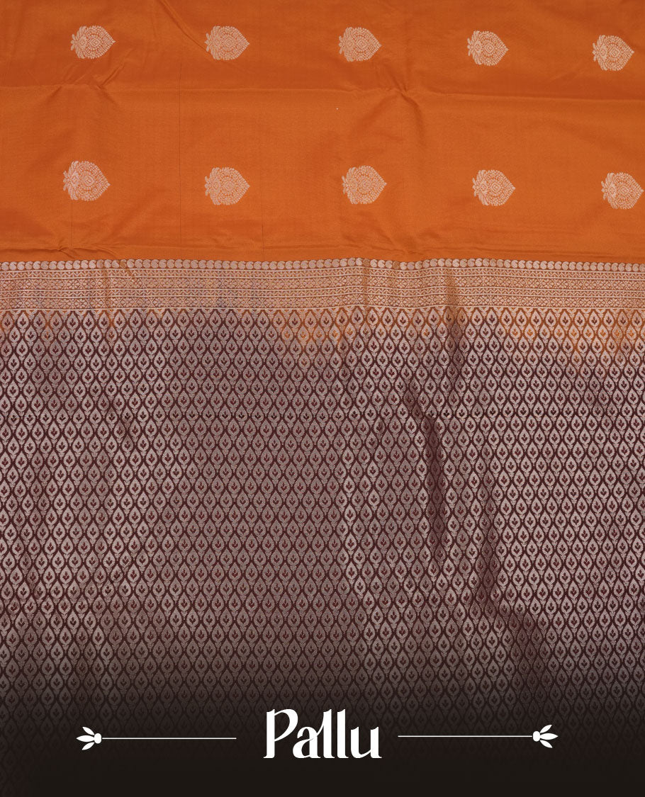 Rust orange colour semi silk saree featuring gold zari floral motifs on body highlighting contrast dark chocolate rose gold zari peacock border , paired with matching blouse